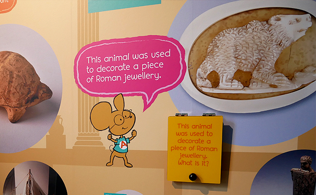 A cartoon mouse tells young visitors about Roman jewellery